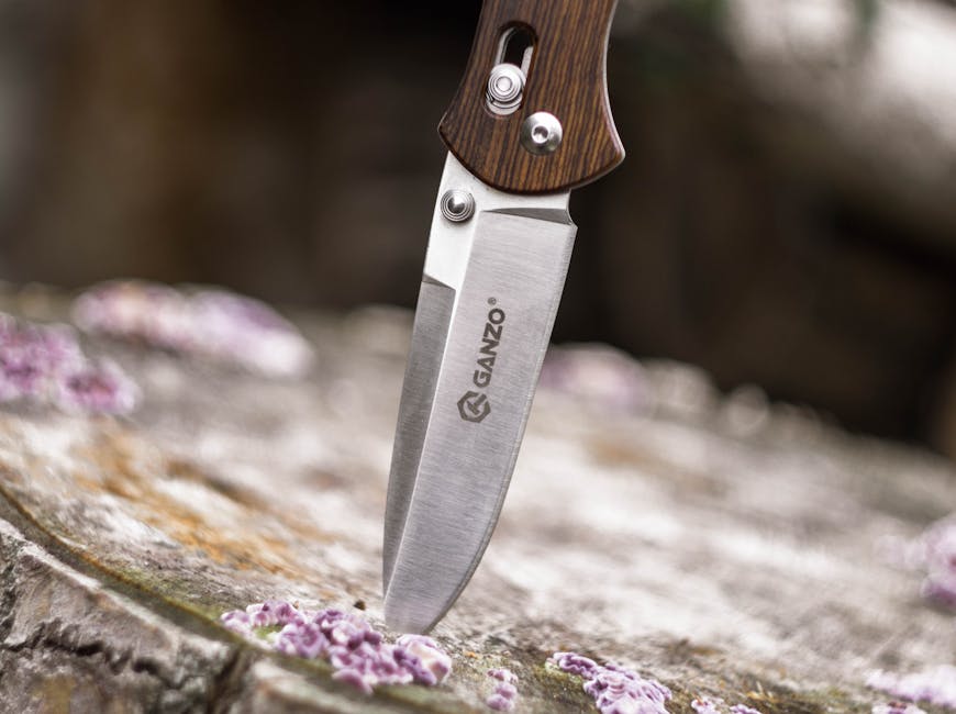 How to Fix a Loose Stacked Leather Knife Pivot Pin 1 Close-up image of a Ganzo knife embedded in wood, highlighting its sharpness and steel texture.